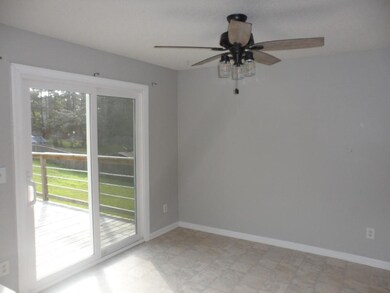 Unfurnished room featuring ceiling fan and baseboards