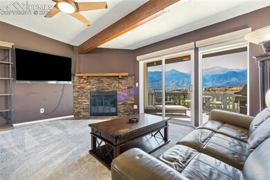Living Room with beamed ceilings, fireplace, and P