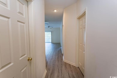 Hall featuring baseboards and wood finished floors