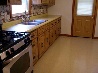 Kitchen. Door to rear Covered Porch