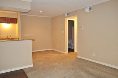 Empty room featuring baseboards, ornamental moldin