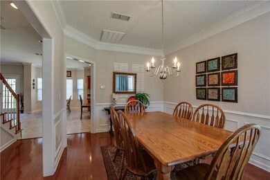 Notice the beautiful wood flooring and wainscoting.  Crown molding adds to the elegance of this room and continues throughout the main level of the home. 