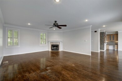 Unfurnished living room with crown molding, a cei