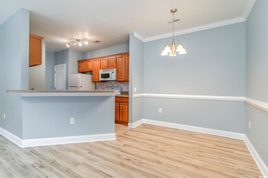 Kitchen with decorative backsplash, a chandelier, 