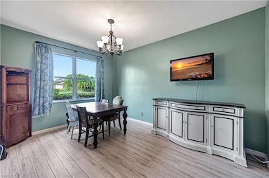 Dining area featuring a notable chandelier and lig