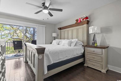 Bedroom with dark wood-style flooring, a ceiling f