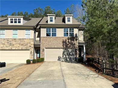 View of front of house with a garage, stone siding