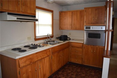 Kitchen with cooktop and wall oven