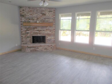 Family Room with warm, corner, raised brick hearth fireplace