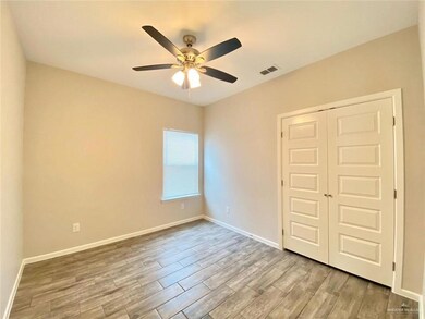 Unfurnished bedroom featuring a closet, wood finished floors, visible vents, ceiling fan, and baseboards