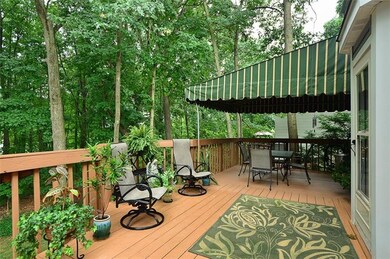 The LARGE elevated deck is accessed from the kitchen or by the stairway off the driveway. The covered portion keeps it shady and cool, yet the open deck area tempts you to tan in privacy.
