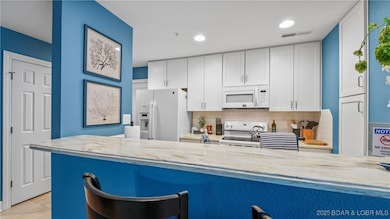 The kitchen has soild surface countertops, upgread