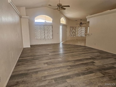 Foyer with a ceiling fan, wood finished floors, an