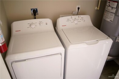 Laundry area featuring water heater and independent washer and dryer
