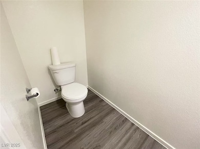 Bathroom with baseboards and wood finished floors