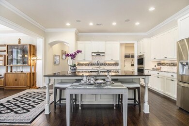 At the heart of the home, a Chef's Kitchen shines with White Cabinetry, Granite Counters, Stainless Steel Appliances, a Walk-In Pantry, and an Oversized Island perfect for Casual Dining or Hosting Guests