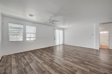 Empty room with dark wood-style flooring, ceiling