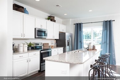 Kitchen featuring a kitchen island with sink, crow