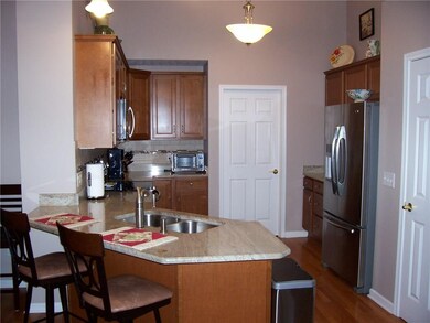 Kitchen boasts granite & stainless under cathedral