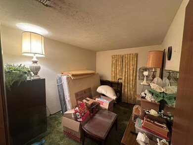 Bedroom with carpet floors and a textured ceiling