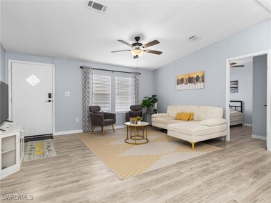 Living room with ceiling fan, light hardwood / woo