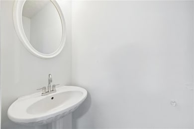 Half Bathroom on main level featuring pedestal sink