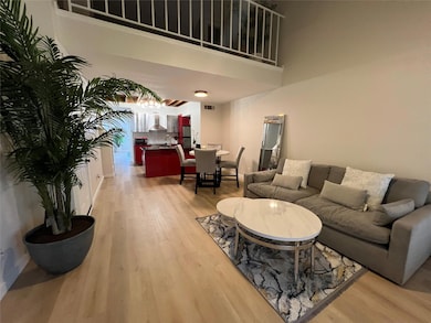 Living room featuring wood-type flooring, a toweri