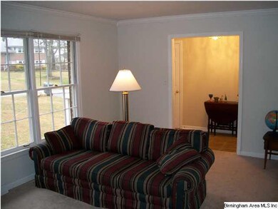 This spacious living room has crown molding and ha
