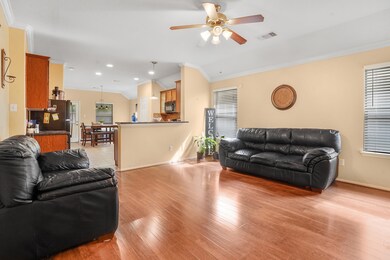 Spacious living area leading into kitchen.