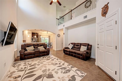 Tiled living area with arched walkways, a ceiling