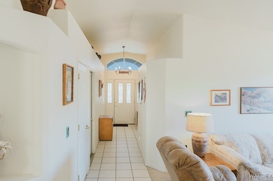 Entryway with an inviting chandelier, light tile p