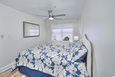 Bedroom with wood finished floors and ceiling fan