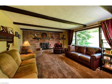 Family room with fireplace and wood beam ceiling.