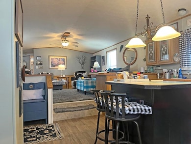 Kitchen with ceiling fan, pendant lighting, hardwo