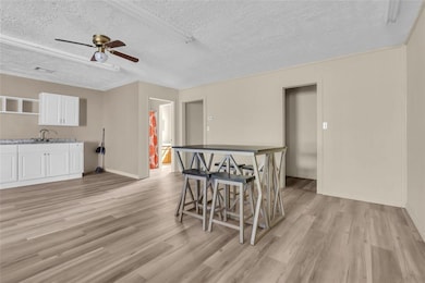 Dining space with a textured ceiling, visible vent