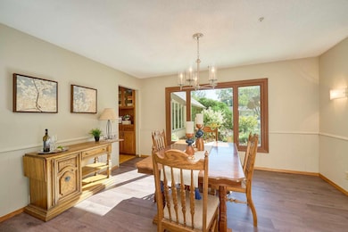 This view shows your Dining Room with a large window wall overlooking your front entrance.