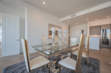 Modern dining area with a sleek glass table and st