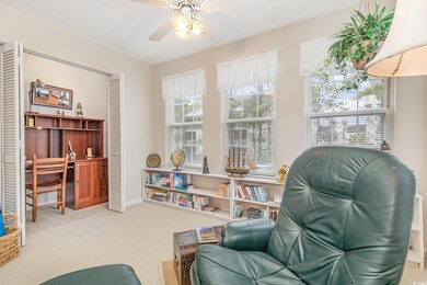 Living area featuring carpet floors, ceiling fan, 