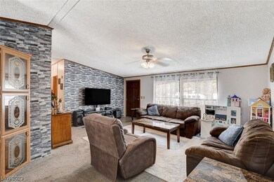 Living area w/ vaulted ceilings facing front door.