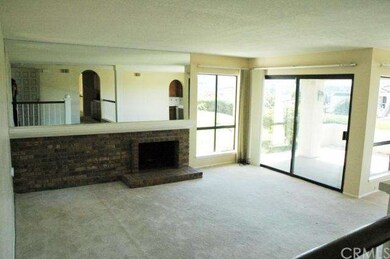 The LR is warmed by an expansive, brick fireplace.