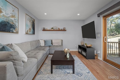 Living area featuring light wood-style flooring and recessed lighting