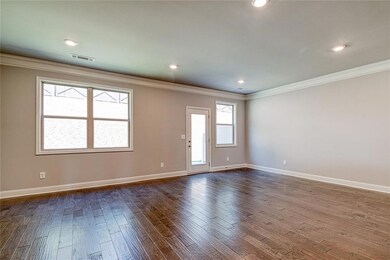Empty room with dark wood finished floors, baseboa