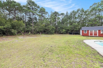 View of green lawn with outdoor pool