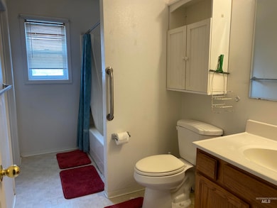 Bathroom featuring vanity and shower / tub combo with curtain