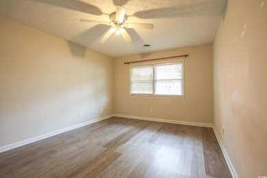 Empty room featuring visible vents, ceiling fan, b