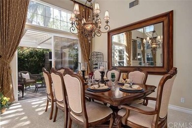 FORMAL DINING ROOM WITH CUSTOM CHANDELIER AND WALL