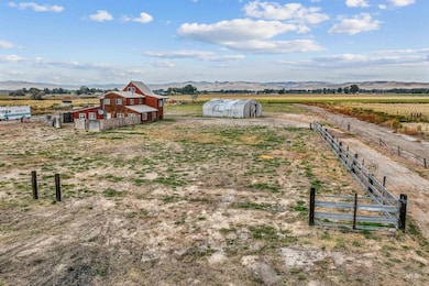View of yard featuring a rural view, an outbuilding, a mountain view, and a barn