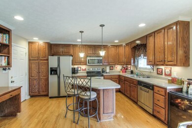 Kitchen With Hardwood Floors, Stainless Appliances, Island, And Ample Cabinets For Plenty Of Storage