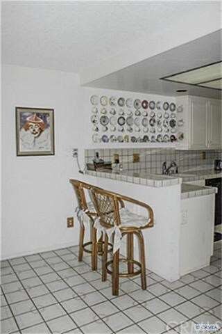 Watch Dad Cook at the Tiled Breakfast Bar