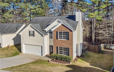 Traditional home featuring a front lawn, driveway,